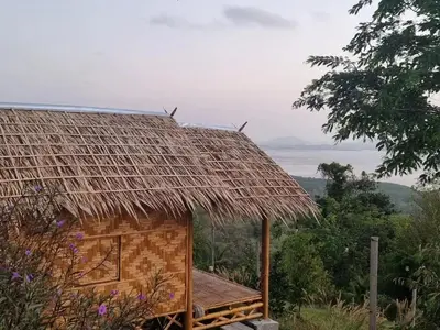 a thatch roofed hut with a view of the ocean at Sea True Valley Phuket ซี ทรู วัลเลย์ ภูเก็ต in Ban Ao Makham