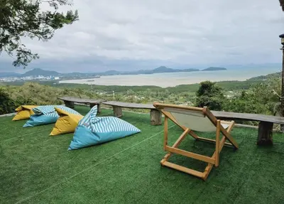 a group of chairs sitting on top of a field of grass at Sea True Valley Phuket ซี ทรู วัลเลย์ ภูเก็ต in Ban Ao Makham