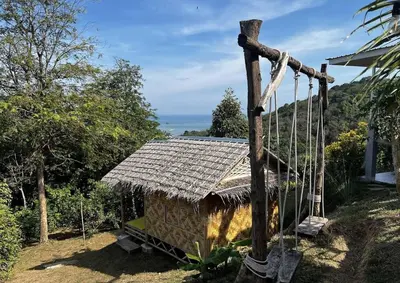 a small house with a thatch roof and a swing at Sea True Valley Phuket ซี ทรู วัลเลย์ ภูเก็ต in Ban Ao Makham