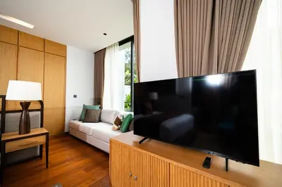a living room with a large flat screen tv at Botanica Foresta - 4 Bedroom Spacious Luxury Pool Villa in Layan in Ban Phru Champa