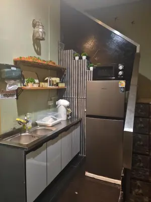 a kitchen with a sink and a refrigerator at TJ Patong HOSTEL in Patong Beach