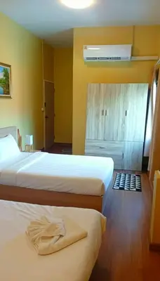 a bedroom with two beds and a air conditioner at I Talay phuket in Karon Beach