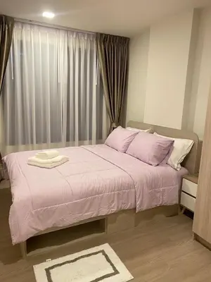 a bedroom with a bed with pink sheets and a window at Dcondo - Kathu, Phuket in Kathu