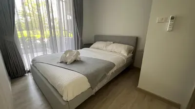 a bed with a stuffed animal sitting on top of it at Sky Park Laguna Phuket in Laguna Phuket
