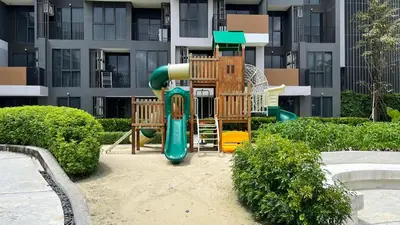 a playground with a slide in front of a building at Sky Park Laguna Phuket in Laguna Phuket