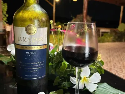 a bottle of wine and a glass of red wine at Phukhao thong in Ban Bang Chak