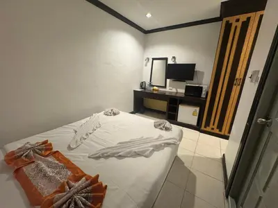 a bedroom with a bed and a desk with a television at Stay at Bedroom in Patong Beach