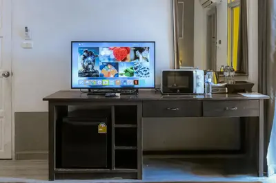 a desk with a computer and a tv on it at Stay at Bedroom in Patong Beach