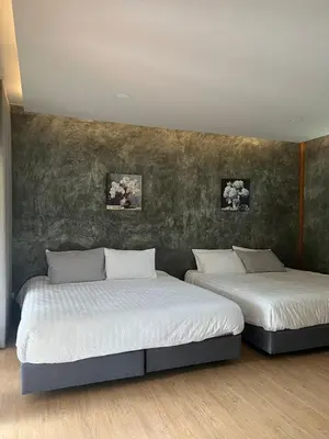 two beds sitting next to each other in a room at maksaihomestay in Ban Lo Pa Ret