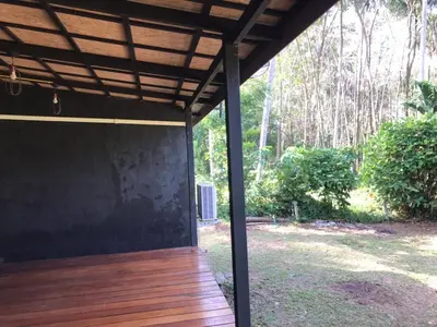 a covered porch with a wooden deck at maksaihomestay in Ban Lo Pa Ret