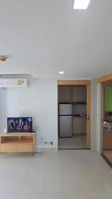 a living room with a flat screen tv on a table at The Feeltrue phuket ck in Ban Klang