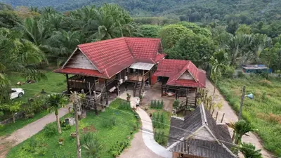 an overhead view of a house with red roofs at Diindanghomestay in Ban Khao Klom