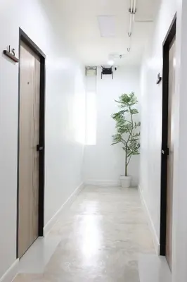 a hallway with a door and a potted plant at Lfour phuket in Phuket Town