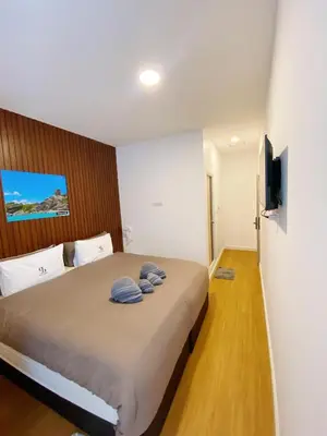 a bedroom with a bed with two towels on it at SJ Beach House Patong in Patong Beach