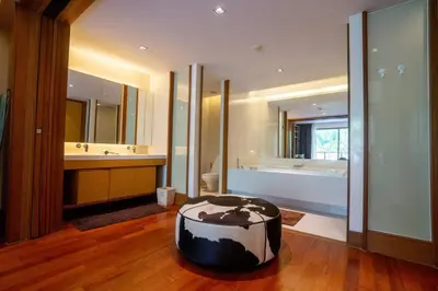 a bathroom with a large tub and a large mirror at Suite of Naithon beachfront apartment in Nai Thon Beach