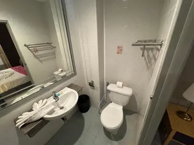 a bathroom with a white toilet and a sink at At bedroom in Patong Beach