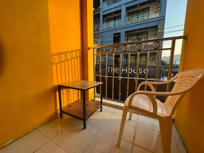 a table and a chair on a balcony at At bedroom in Patong Beach