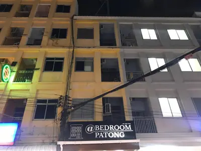 a building with a sign in front of it at At bedroom in Patong Beach