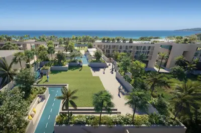 an aerial view of a park with palm trees and buildings at Laguna beachside residences by My home Phuket in Bang Tao Beach