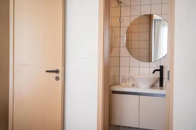 a bathroom with a sink and a mirror at Japanese-Style Condo close Kamala Beach in Kamala Beach