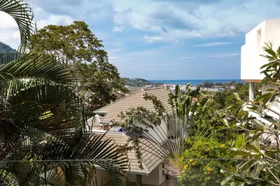 a view from a balcony of a house with plants at Nature and Sea View Terrace, Designer 2BR Villa Natural Touch A1, Kamala in Kamala Beach