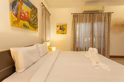 a white bed in a room with a window at V170 4BR Timbuktu villa, Jacuzzi Walk Villa Market in Chalong