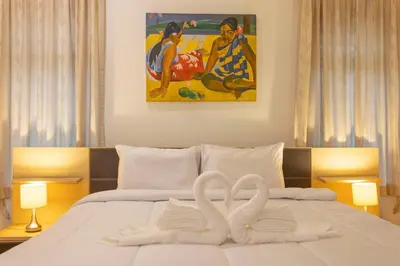 two swans made out of towels on a bed at V170 4BR Timbuktu villa, Jacuzzi Walk Villa Market in Chalong