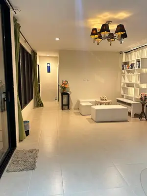 a large living room with a couch and a table at Theclickguesthouse in Ban Bang Chak
