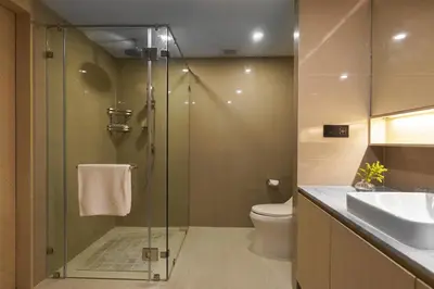 a bathroom with a shower and a toilet and a sink at Amazing View Duplex La Vita in Phuket Town