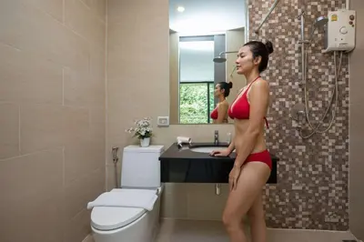 a woman in a red bikini standing in a bathroom at 4BR Villa B5 with Pool, Vibrant Life at Kata Beach - UTK5 in Kata Beach