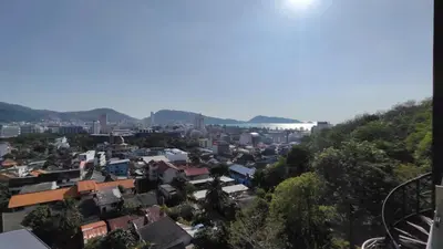 a view of a city with mountains in the background at Emerald Terrace Resort 2 bedrooms Panoramic Ocean View Top Floor in Patong Beach