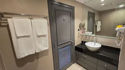 a bathroom with a sink and a mirror at Allamanda Laguna in Laguna Phuket