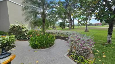 a garden with flowers and plants on a sidewalk at Allamanda Laguna in Laguna Phuket