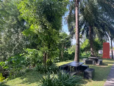 a park with two picnic tables and palm trees at Chic Condo Karon A512 in Karon Beach