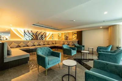 a waiting room with blue chairs and a couch at Wonderful View Duplex in La Vita in Rawai Beach
