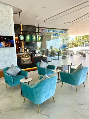 a lobby with blue chairs and tables in a store at Wonderful View Duplex in La Vita in Rawai Beach