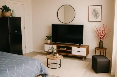 a bedroom with a flat screen tv and a mirror at CİMELi Guest House in Patong Beach