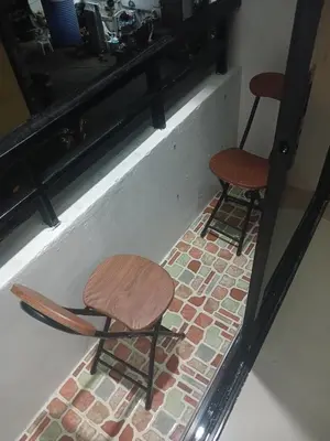 two chairs sitting on a brick floor next to a counter at CİMELi Guest House in Patong Beach