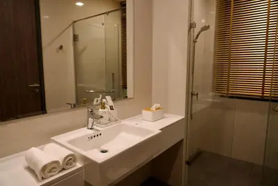 a white bathroom with a sink and a shower at Private pool villa bangtao - laguna park in Ban Phru Champa