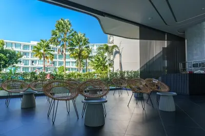 a group of chairs and tables on a balcony at Super Studio La Vita 2 pool in Rawai Beach