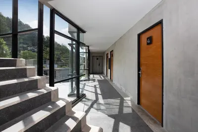 a hallway of a house with a wooden door at Embrace Nature, Comfort & Beach Proximity - Natural Park B24 Suite, Kamala in Kamala Beach