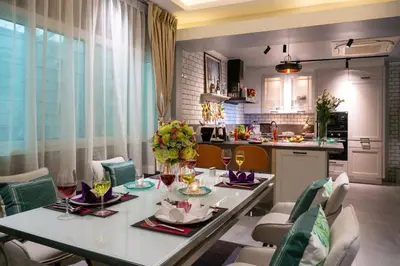 a dining room with a table and chairs and a kitchen at 2 bedrooms Amani Pool Villa Phuket in Thalang