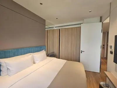 a bedroom with a large bed with white pillows at Modern apartment Layan Beach in Layan Beach