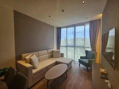 a living room with a couch and two chairs at Modern apartment Layan Beach in Layan Beach