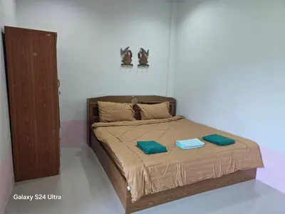 a bedroom with a bed with two pillows on it at NW House in Ao Nang Beach