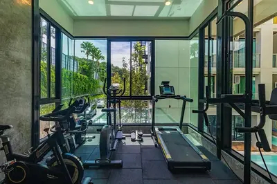 a gym with several tread machines in a building at Peacefull new condo Patong in Patong Beach