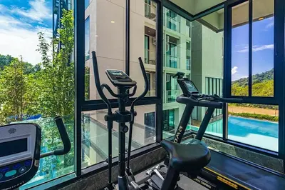 a room with a gym with a treadmill and a window at Peacefull new condo Patong in Patong Beach