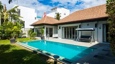 a swimming pool in front of a house at Naiharn Beach 3 bedrooms villa in Rawai Beach