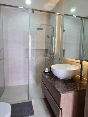 a bathroom with a white sink and a shower at Condo with Roof top sea view in Rawai Beach