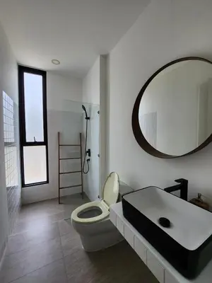 a bathroom with a sink and a toilet and a mirror at Zen House Mono in Ban Na Bon